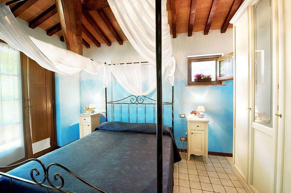 Postel nebo postele na pokoji v ubytování Agriturismo Gattogiallo