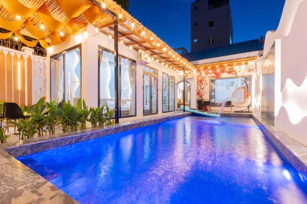 an indoor swimming pool in a house with lights on it at Victory Villa 13 - Đi Bộ Ra Biển Bãi Sau in Vung Tau