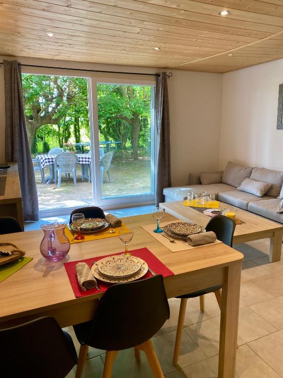 un salon avec une table en bois et un canapé dans l'établissement Le Gîte des poiriers, à Uzès