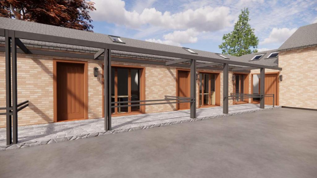 a rendering of a building with a garage at The Stables at Minstrel Court in Cambridge