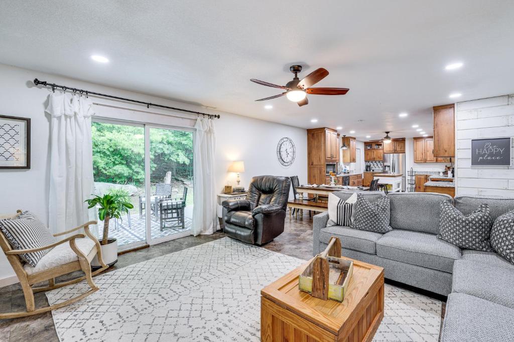 a living room with a couch and a table at VIEWS! Lake Home w/ 2 Decks, Boat Parking & Peace in Garfield