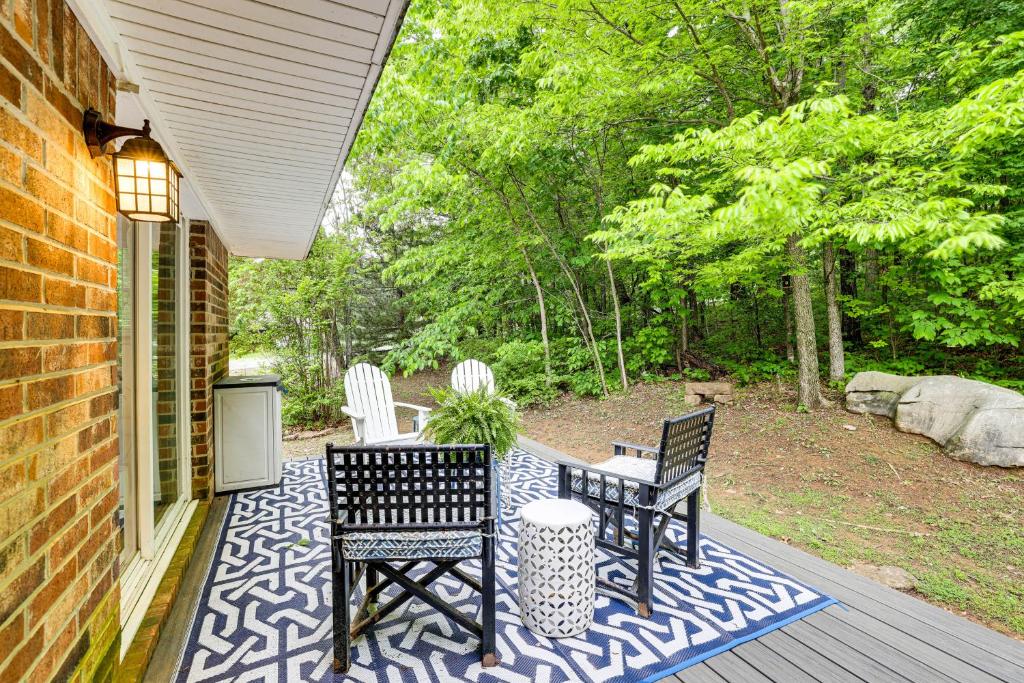 a patio with two chairs and a table on a porch at Beaver Lake Getaway with 2 Decks, Grill, and Views! in Garfield