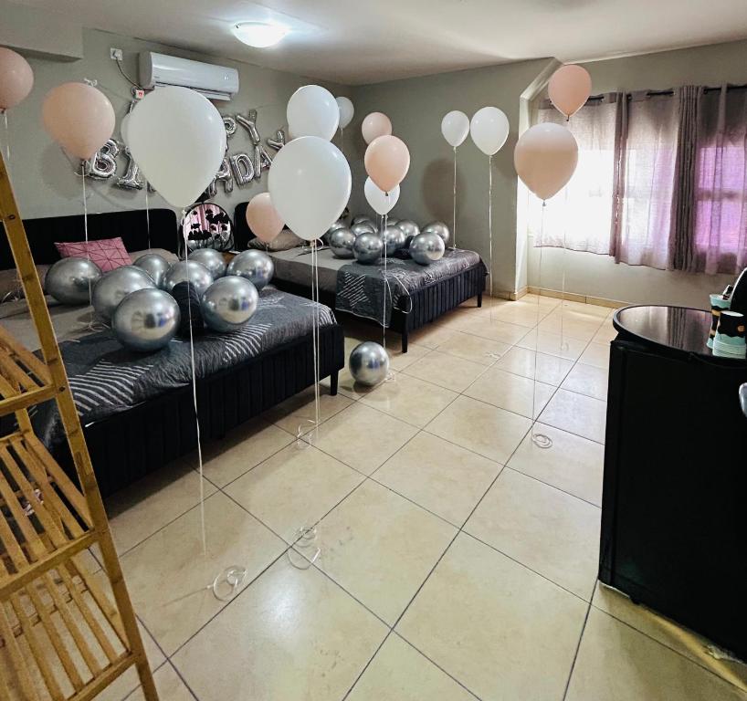 a room with balloons and couches in a room at Roof top glamping and Toys suites in Eilat