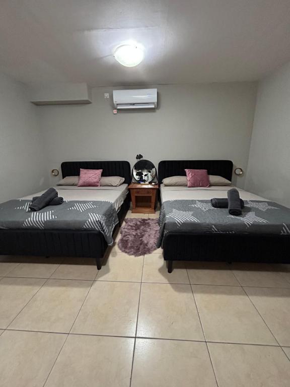 a room with two beds and a table in it at Roof top glamping and Toys suites in Eilat