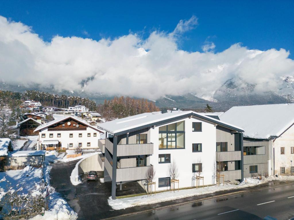 an apartment building with a snow covered roof at Apartment be home by Interhome in Mieming