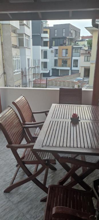 two chairs and a table on a balcony at MaxiMo in Ruse