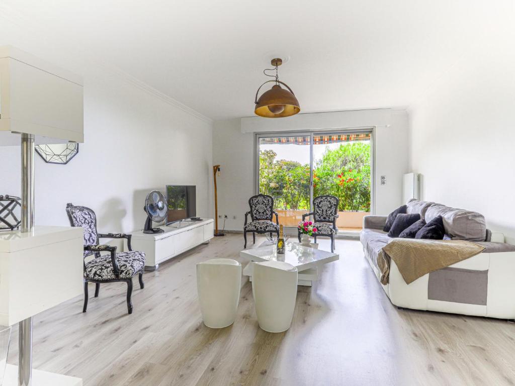 a living room with a couch and a table at Apartment Les Balcons d'Eze-3 by Interhome in Èze