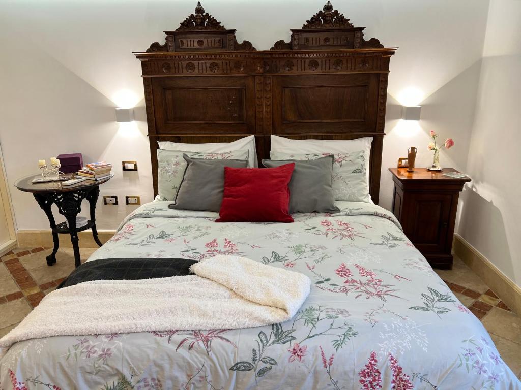 Schlafzimmer mit einem großen Bett mit einem Kopfteil aus Holz in der Unterkunft la casetta tra la laguna e il mare Poetto in Cagliari