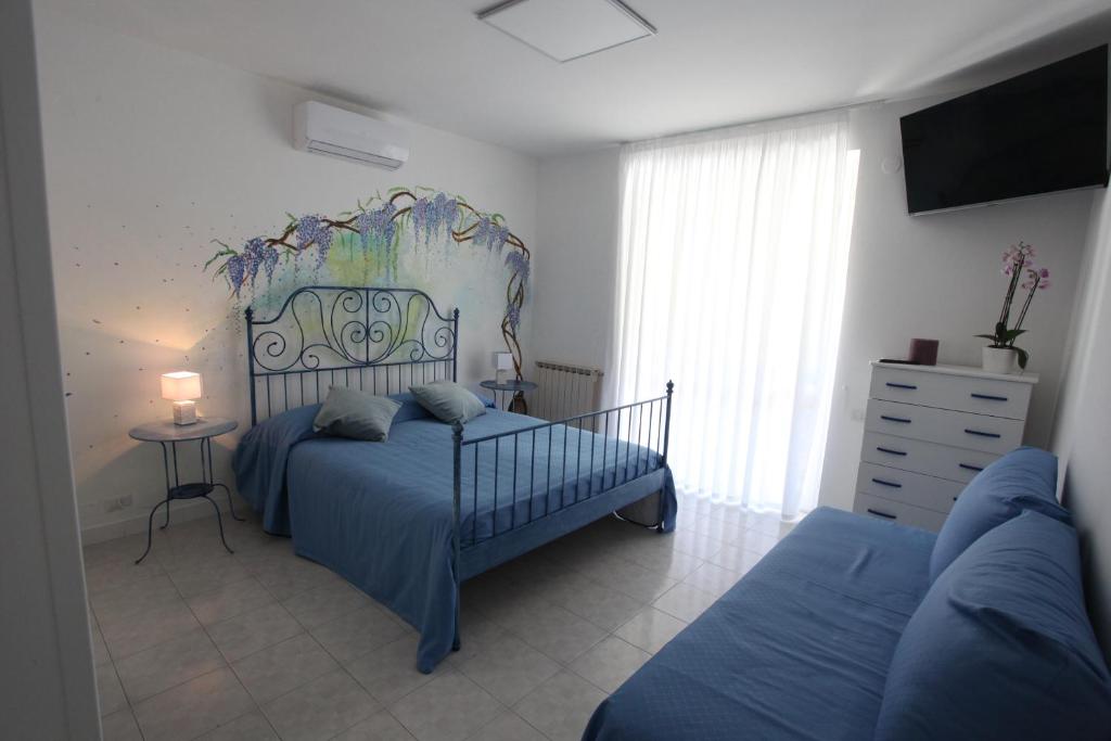 a bedroom with a bed and a dresser and a tv at Jungle Rooms in Cetara