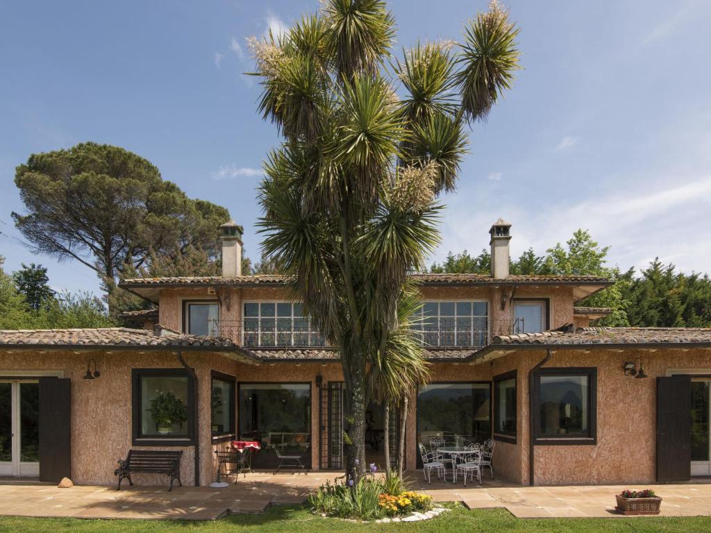 a palm tree in front of a house at Villa Villa Oriental by Interhome in Genazzano