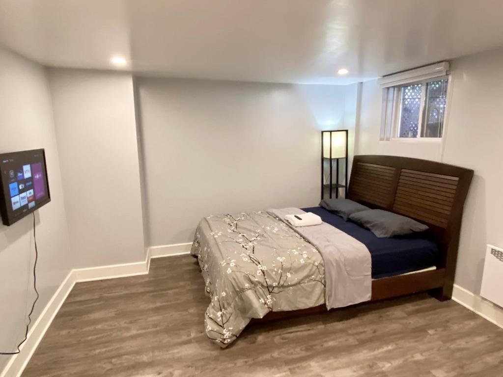 a bedroom with a bed and a tv in it at MontREAL HOMES - Affordable Rooms, Smart TV, Shared Kitchen in Montréal