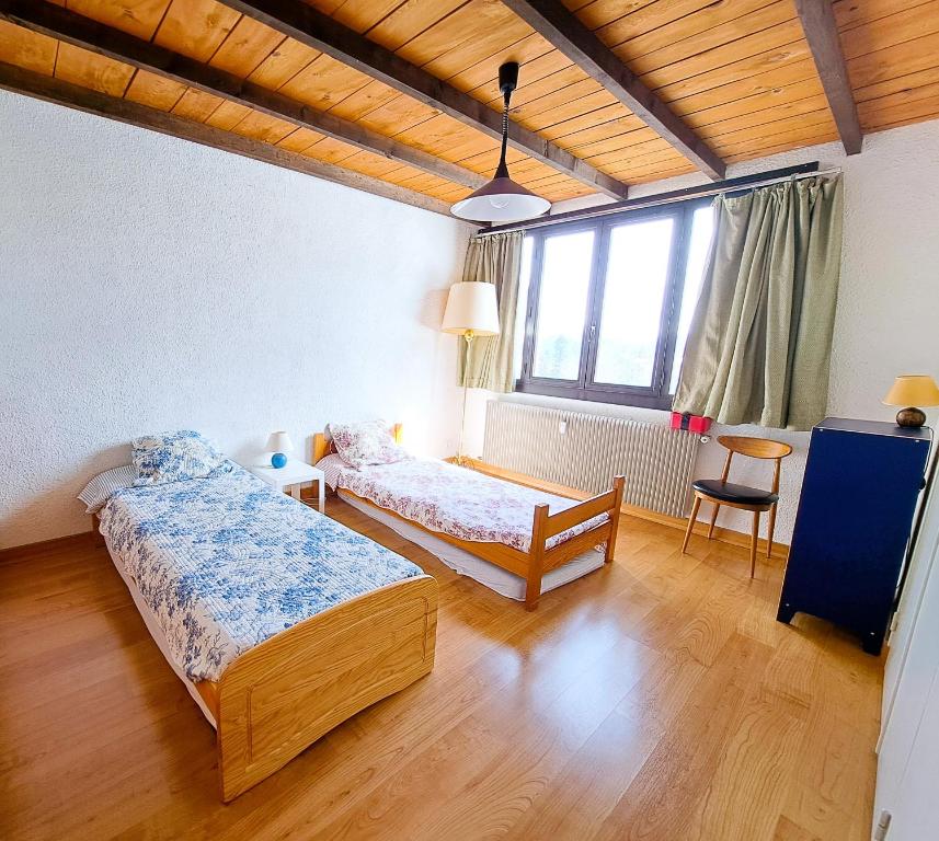 A bed or beds in a room at Location Pra-Loup Vacances