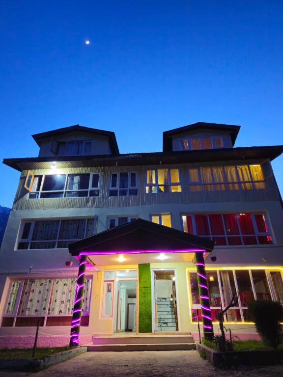 a building with a lit up facade at night at New Snow View Resort pahalgam in Pahalgām