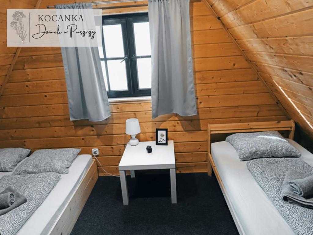 Postel nebo postele na pokoji v ubytování Domek w Puszczy ,,Kocanka"