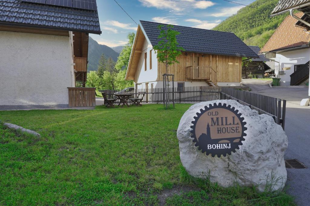 ein Schild für ein Mühlenhaus vor einem Haus in der Unterkunft Old Mill House in Bohinj