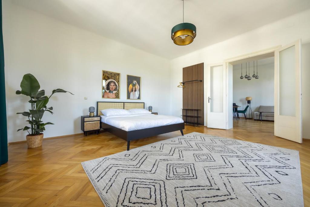 a bedroom with a bed and a rug at Imperial City Apartment in Vienna