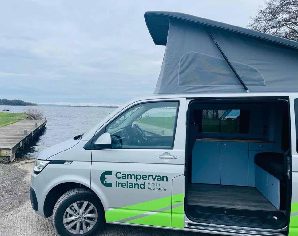 une camionnette blanche garée à côté d'une masse d'eau dans l'établissement Campervan Ireland Rentals, à Dardistown