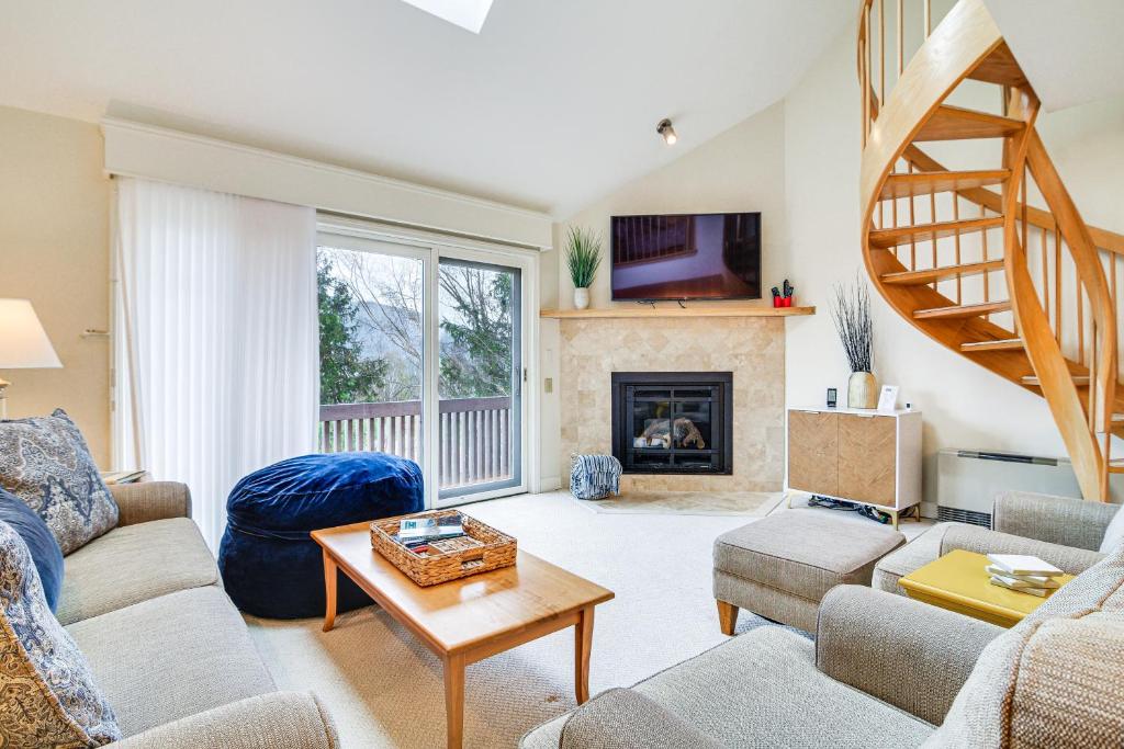 a living room with a couch and a fireplace at Cozy Jackson Condo with Mtn Views and Pool Access! in Bartlett