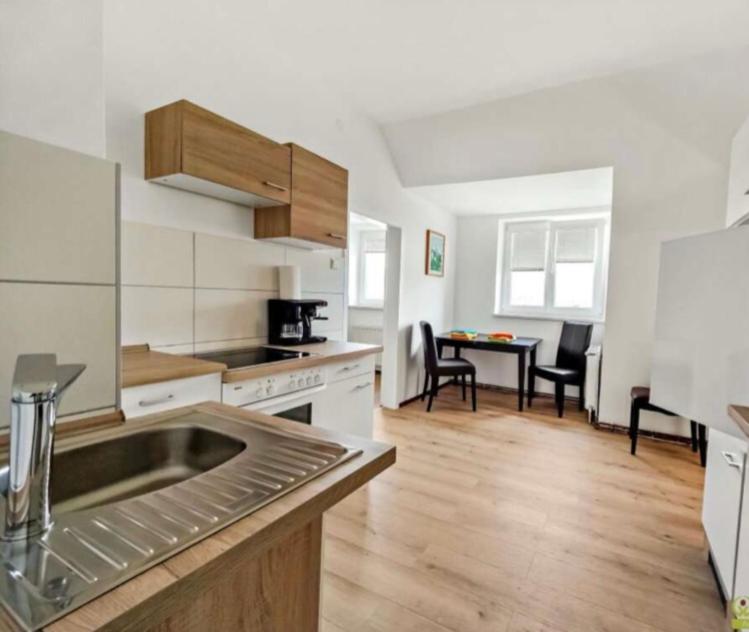 a kitchen with a sink and a table with chairs at YveBeaRoe in Knittelfeld