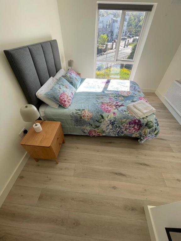 a bedroom with a bed and a window at Luxury King Size Bed Sandyford Mountain View in Sandyford