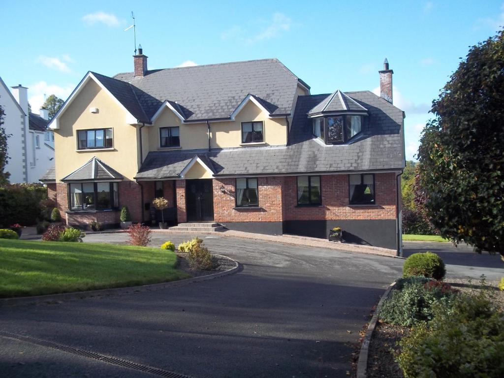 a large house on a street with a driveway at Grove Lodge B&B in Monaghan