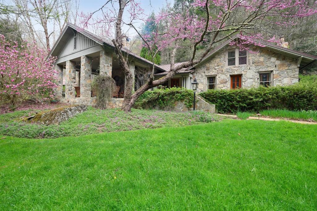 a stone house with a tree in a yard at Entire Estate-High Country-Valle Crucis-Sleeps 12 in Valle Crucis