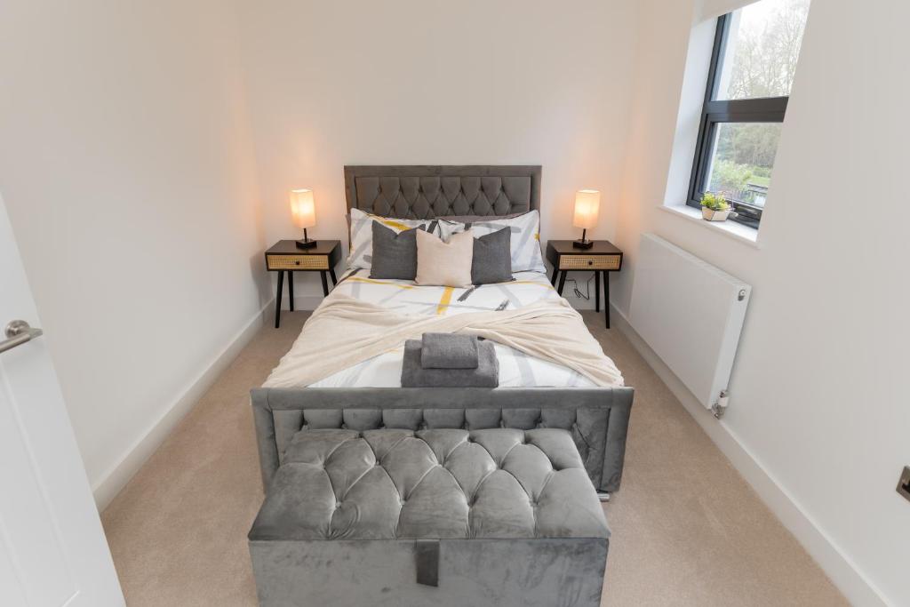 a bedroom with a large bed with two tables at The Broad Oaks in Olton