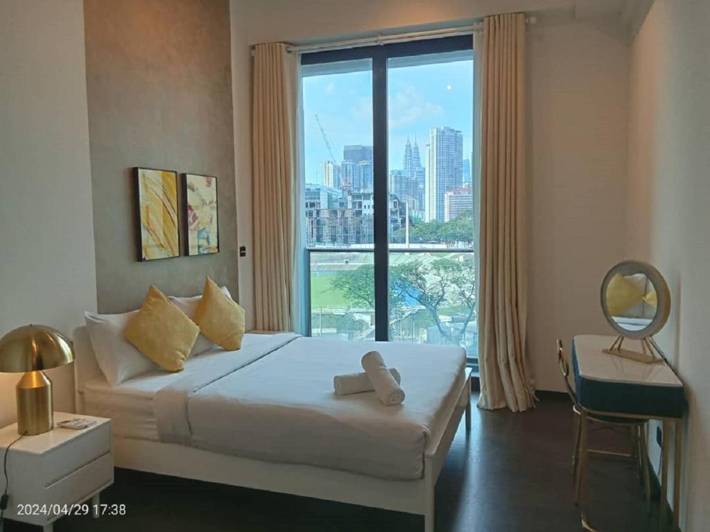 a bedroom with a bed and a large window at Opus Residence 118 tower view by Square in Kuala Lumpur