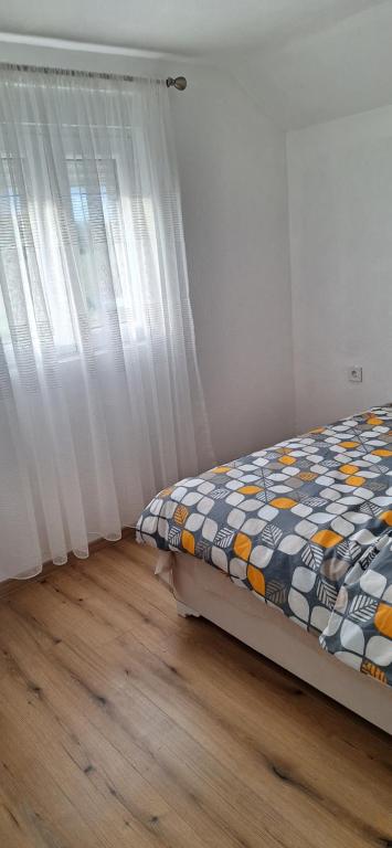 Postel nebo postele na pokoji v ubytování Apartments Bajceta