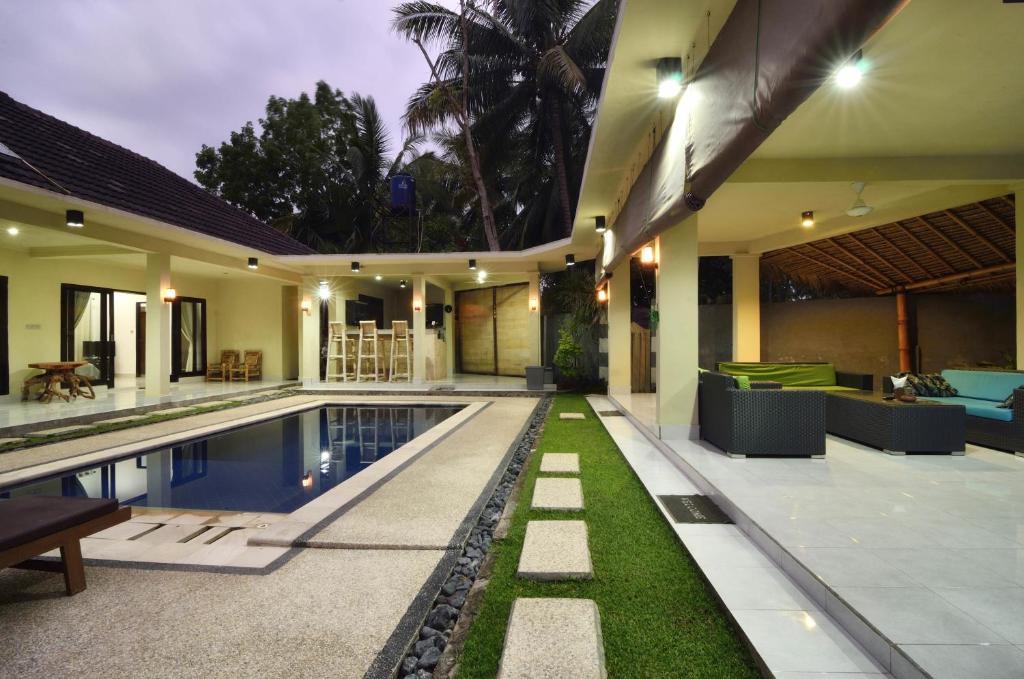 an external view of a villa with a swimming pool at Santai Villa in Kuta Lombok