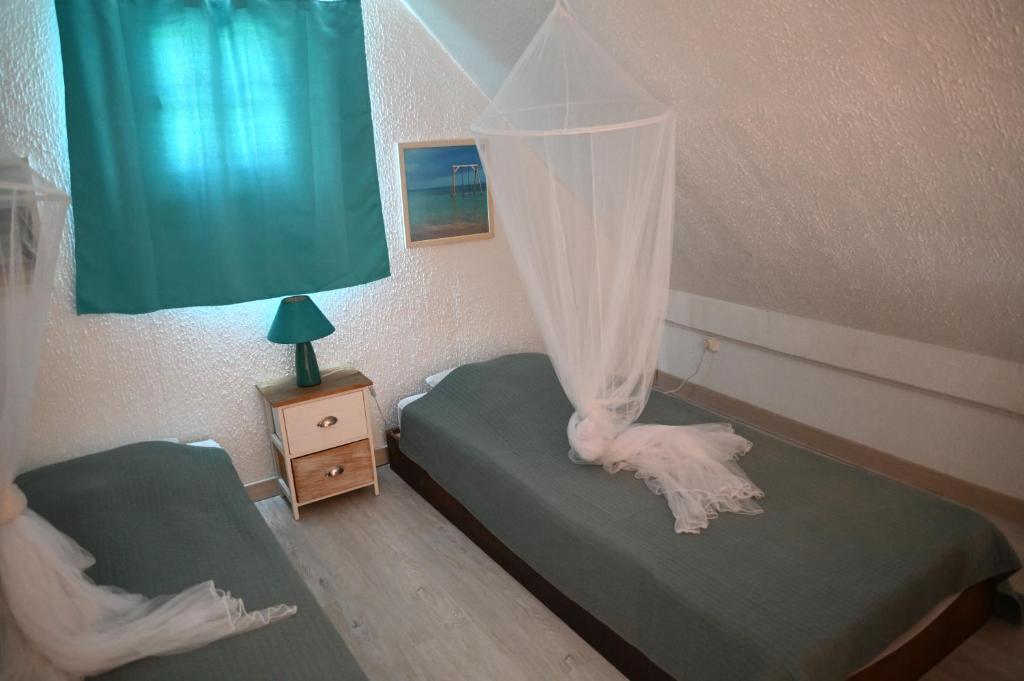 Postel nebo postele na pokoji v ubytování LA CAZ'ANOLI