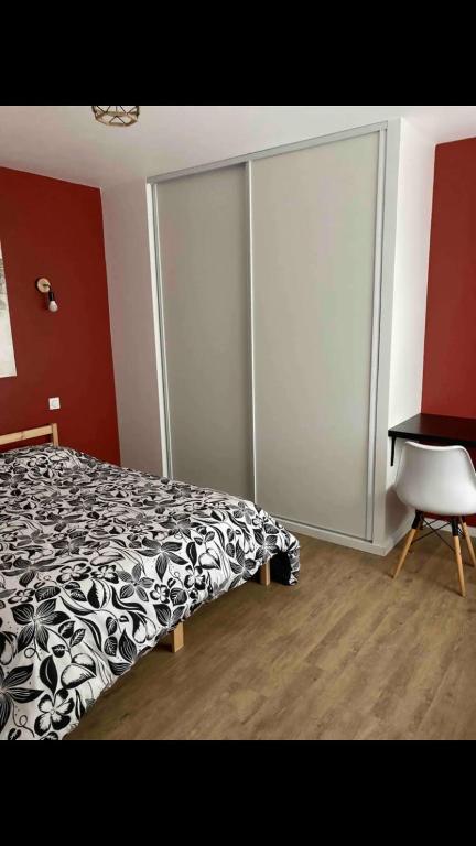 a bedroom with a black and white bed and a desk at Centre Quimper, animaux déclarés acceptés in Quimper