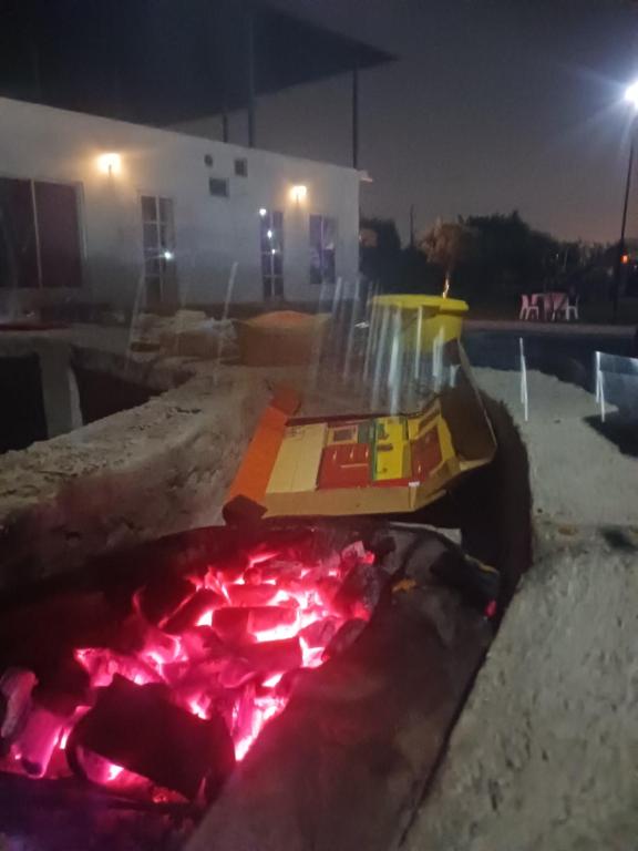 a toy boat in a fire pit at night at Sun n moon farm in Noida