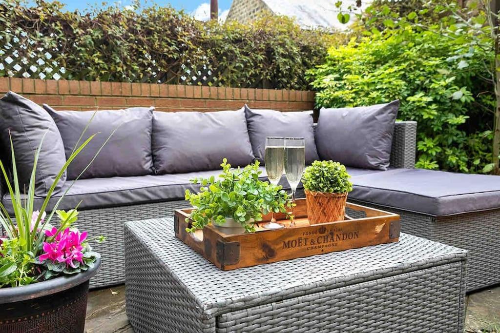 a patio with a couch and a table with plants at The Stanley Suite 1 bedroom apt Dog friendly Patio in Harrogate