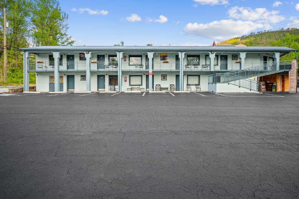 a large building with a parking lot in front of it at Country Town N' Suites in Gatlinburg