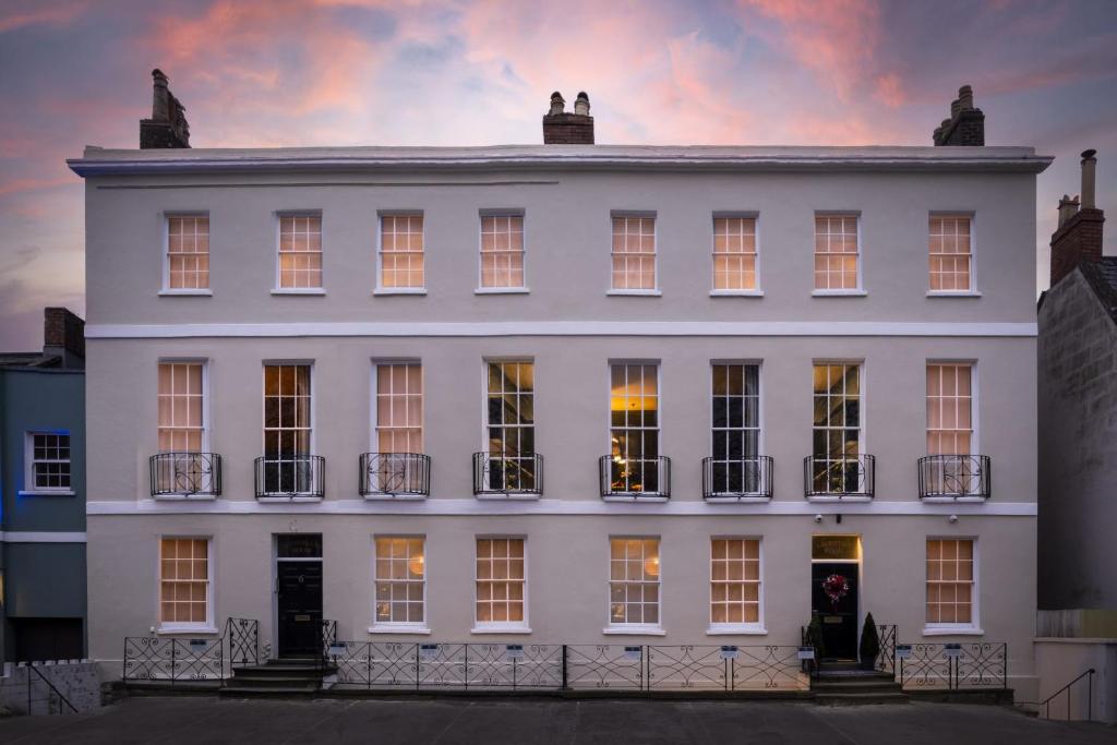 a white building with a sunset in the background at 5&6 North Place in Gloucestershire