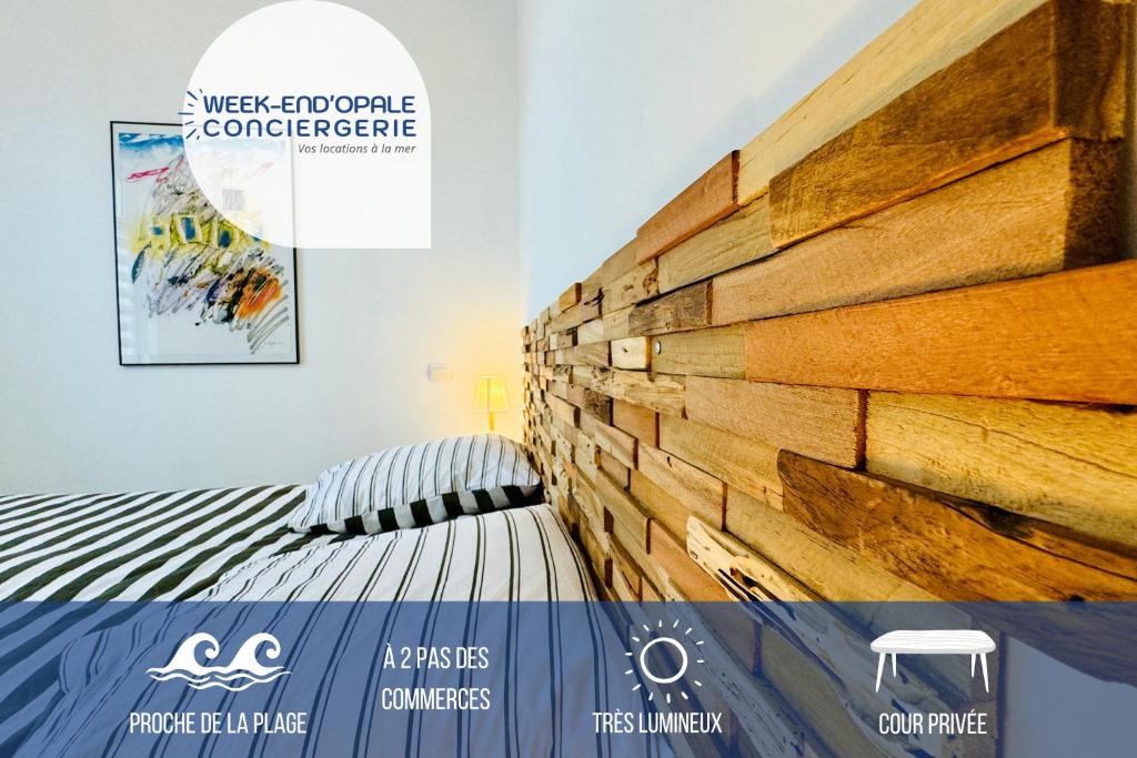 a bedroom with a wall made out of wood at La scintillante au coeur de Merlimont Plage in Merlimont