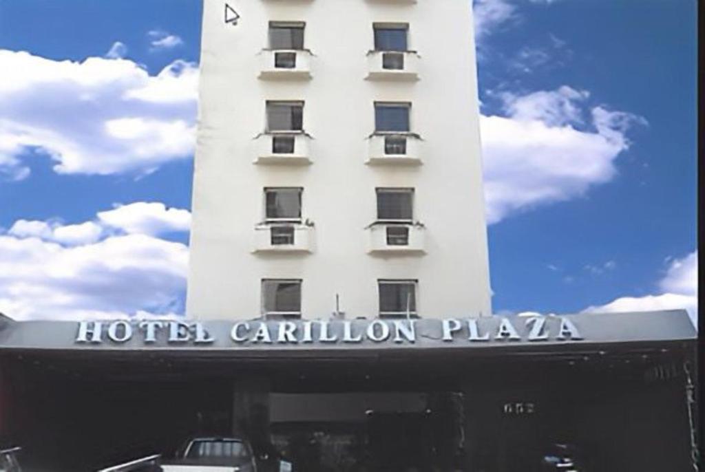 a white hotel building with a sign on it at Carillon Plaza Hotel in Sao Paulo