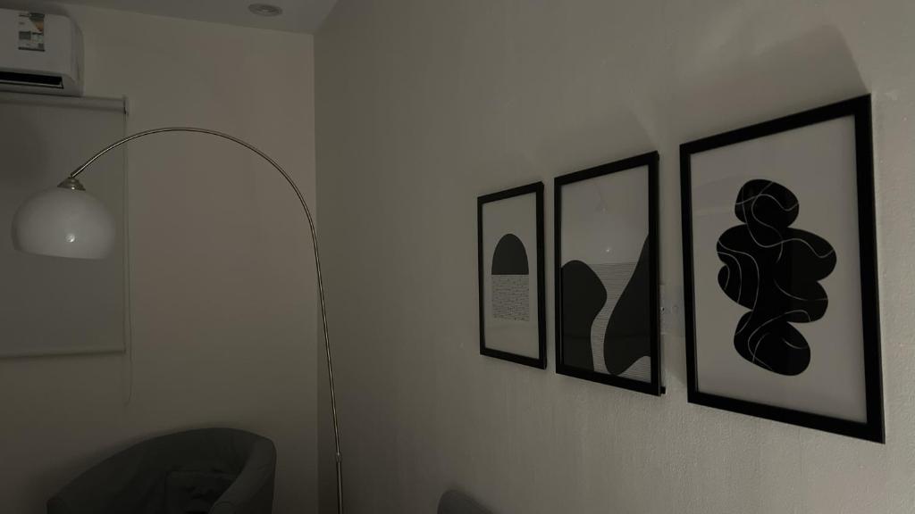 a room with four pictures on a wall at غرفة و حوش بمدخل خاص و دخول ذكي in Riyadh