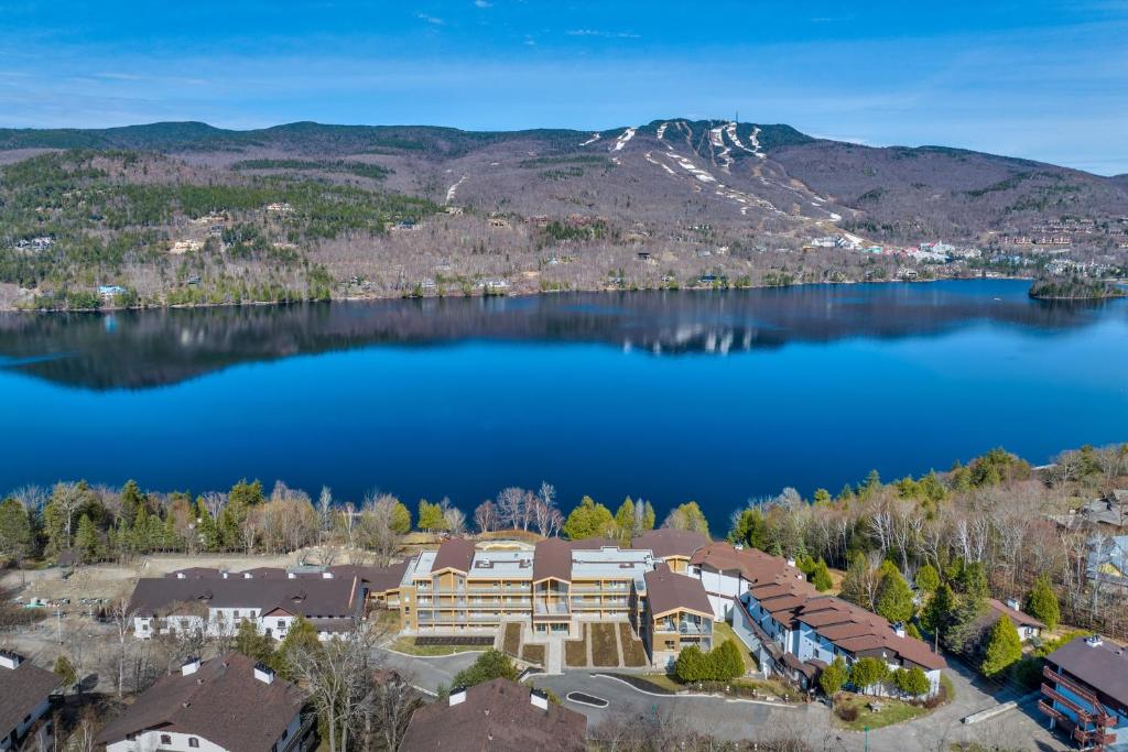 an aerial view of a house on the shore of a lake at Lago by Tremblant Platinum in Mont-Tremblant