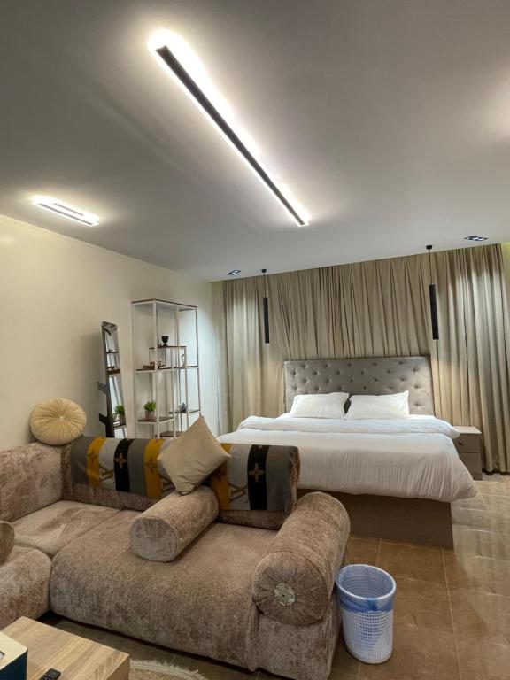 a large bedroom with a bed and a couch at نزل بسمة الأبداع in Abha