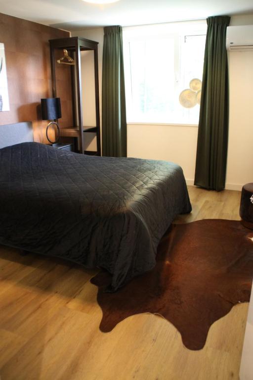 Ένα ή περισσότερα κρεβάτια σε δωμάτιο στο Huisje Wenum - Apeldoorn met jacuzzi