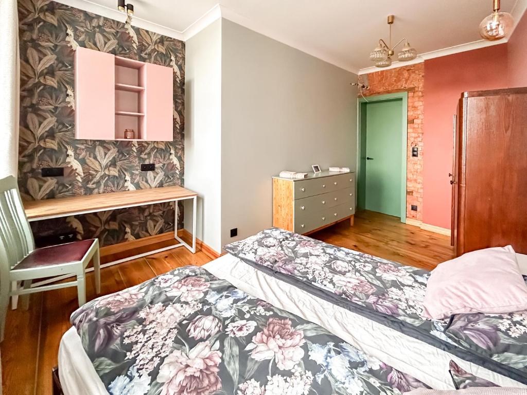a bedroom with two beds and a green door at Central Old Town Apartment in Gdańsk