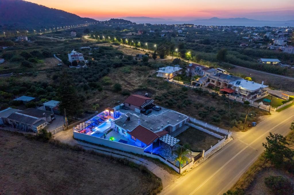 an aerial view of a house with a swimming pool at Near Airport Studios in Kremasti