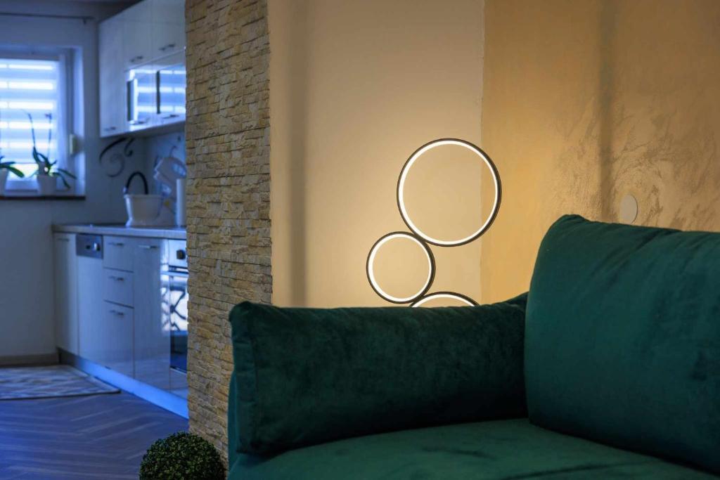 a living room with a couch and two mirrors on the wall at Apartman Toni in Krk