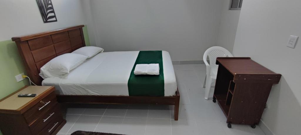 Schlafzimmer mit einem Bett, einer Kommode und einem Schreibtisch in der Unterkunft Amaca Suites in Santa Cruz de la Sierra