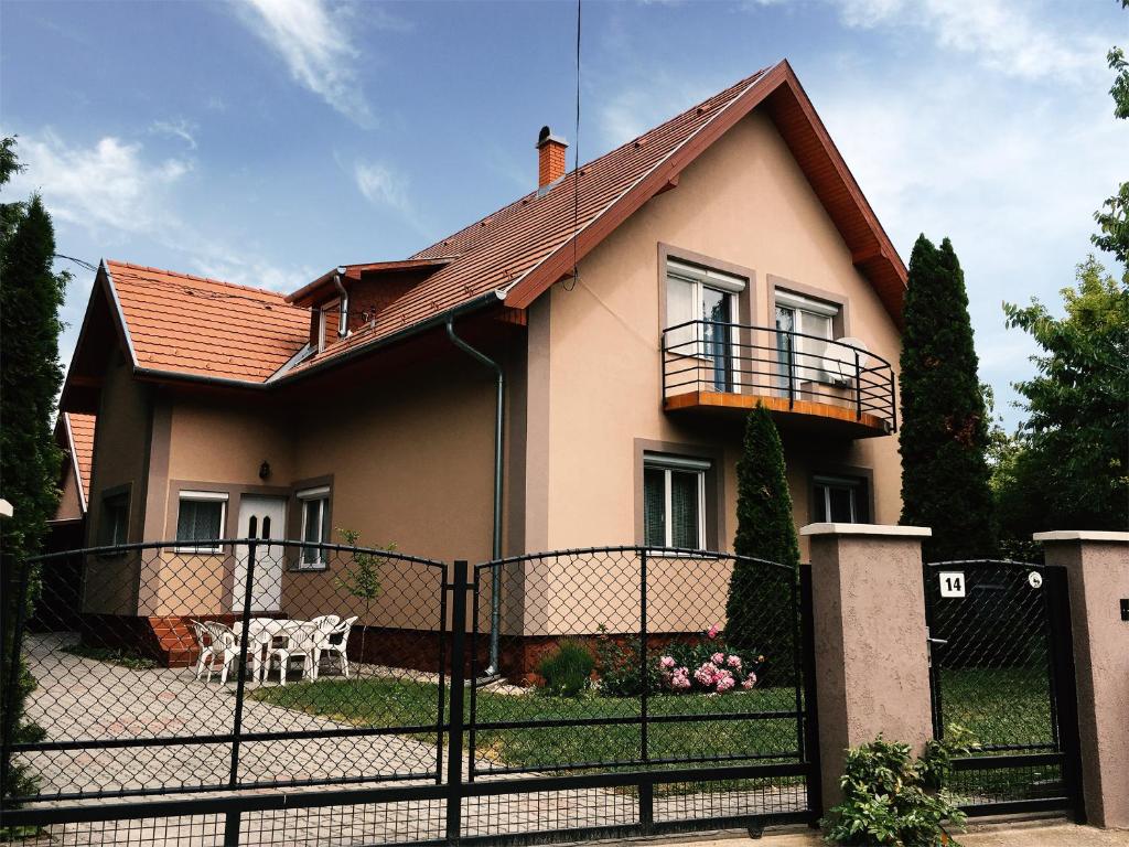 a house with a fence in front of it at Lavender Apartment in Siófok