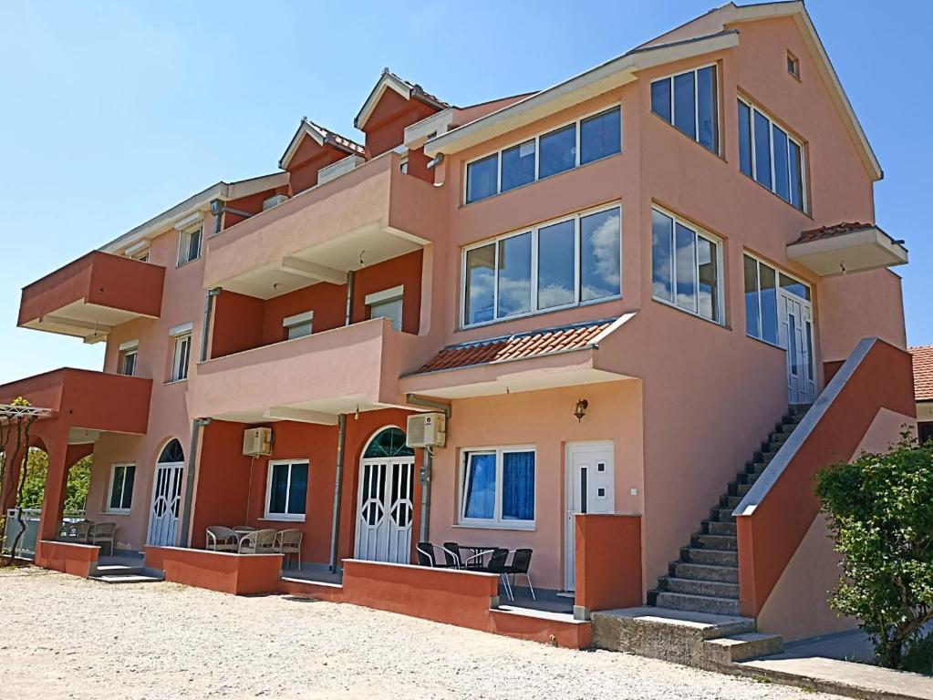 a large house with a lot of windows at Apartmani Slađo in Trebinje