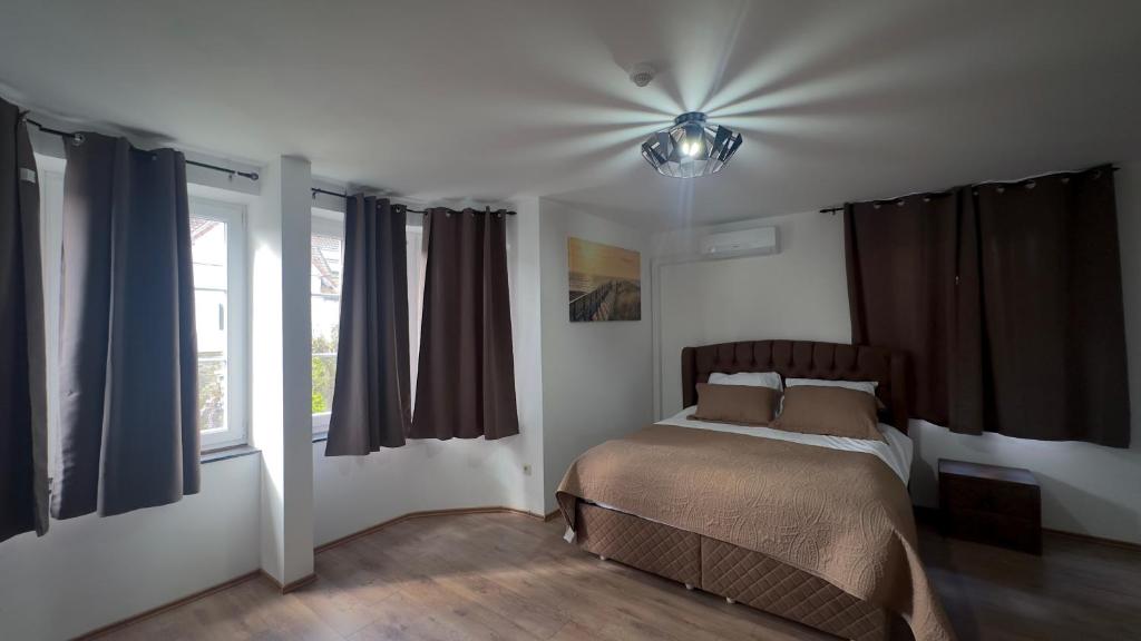 a bedroom with a bed and a ceiling fan at Ardenne in Spa