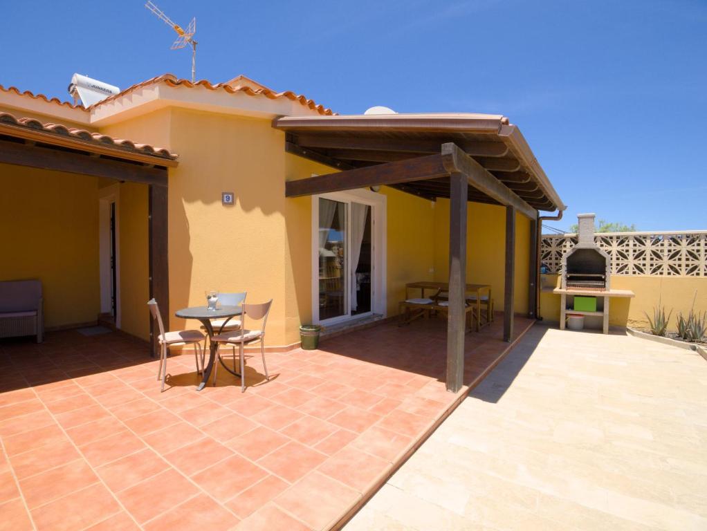 a patio of a house with a table and chairs at Casa Nicole in Caleta De Fuste